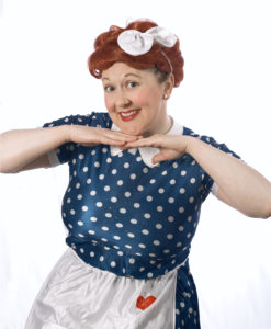 Image description: Elizabeth, a white woman and Deaf signing actor, is dressed as Lucile Ball from I Love Lucy.